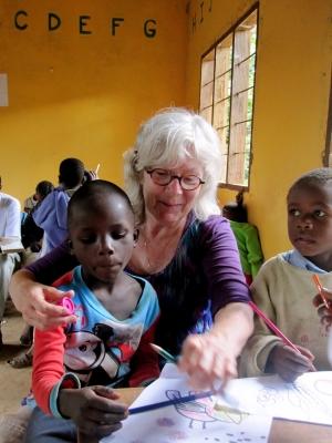 Older volunteer with 1 child on a care project
